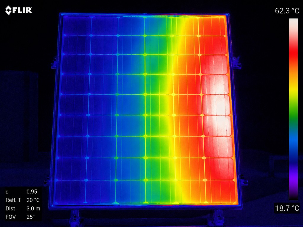 Thermal image of a solar panel showing a hotspot - cooler cells in blue and purple, overheating cells in red and white